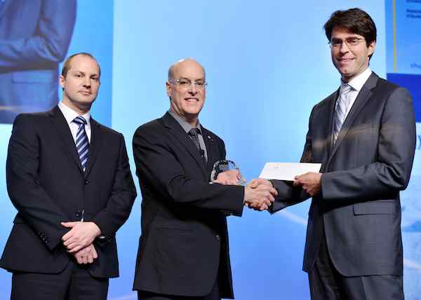 Dr. Louis Fortier (centre) accepts The Weston Family Prize for Lifetime Achievement in Northern Research from Christian Bauta, Director, The W. Garfield Weston Foundation (far right) and Michael Goodyear, Executive Director, Churchill Northern Studies Centre (far left), at the 2012 International Polar Year Conference in Montréal. (CNW Group/The W. Garfield Weston Foundation)