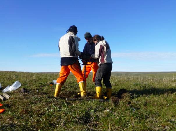The coring team working to get the core barrel out of the ground in Herschel Island 