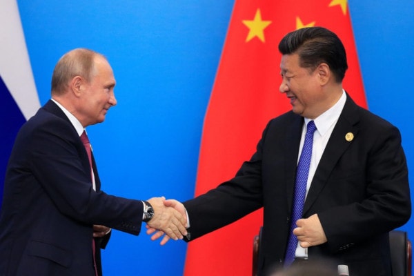 Xi Jinping and Vladimir Putin shake hands during Shanghai Cooperation Organization (SCO) summit in Qingdao