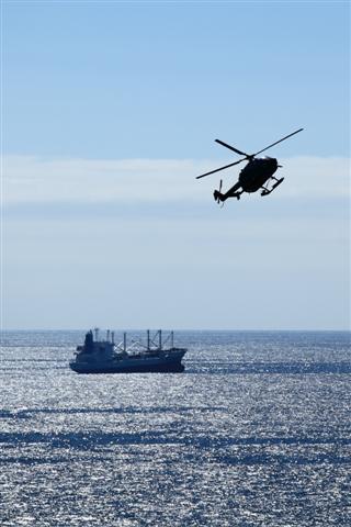 Helicopter and a vessel in the Arctic ocean